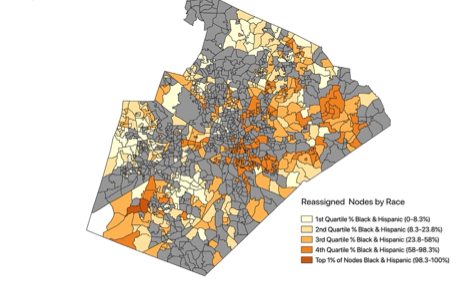 County map of Wake County, North Carolina filled in gray, tan, orange and red. The legend is titled Reassigned nodes by race. The first four colors are labeled first through fourth quartile black and hispanic, which ranges from 0% up to 98.3 percent. The darkest color is top one percent of nodes black and hispanic, ranging from 98.3 to one hundred percent. The darker colors are generally concentrated in the center of the county and the south west parts of the county. Most of the map is gray, which is not on the legend.